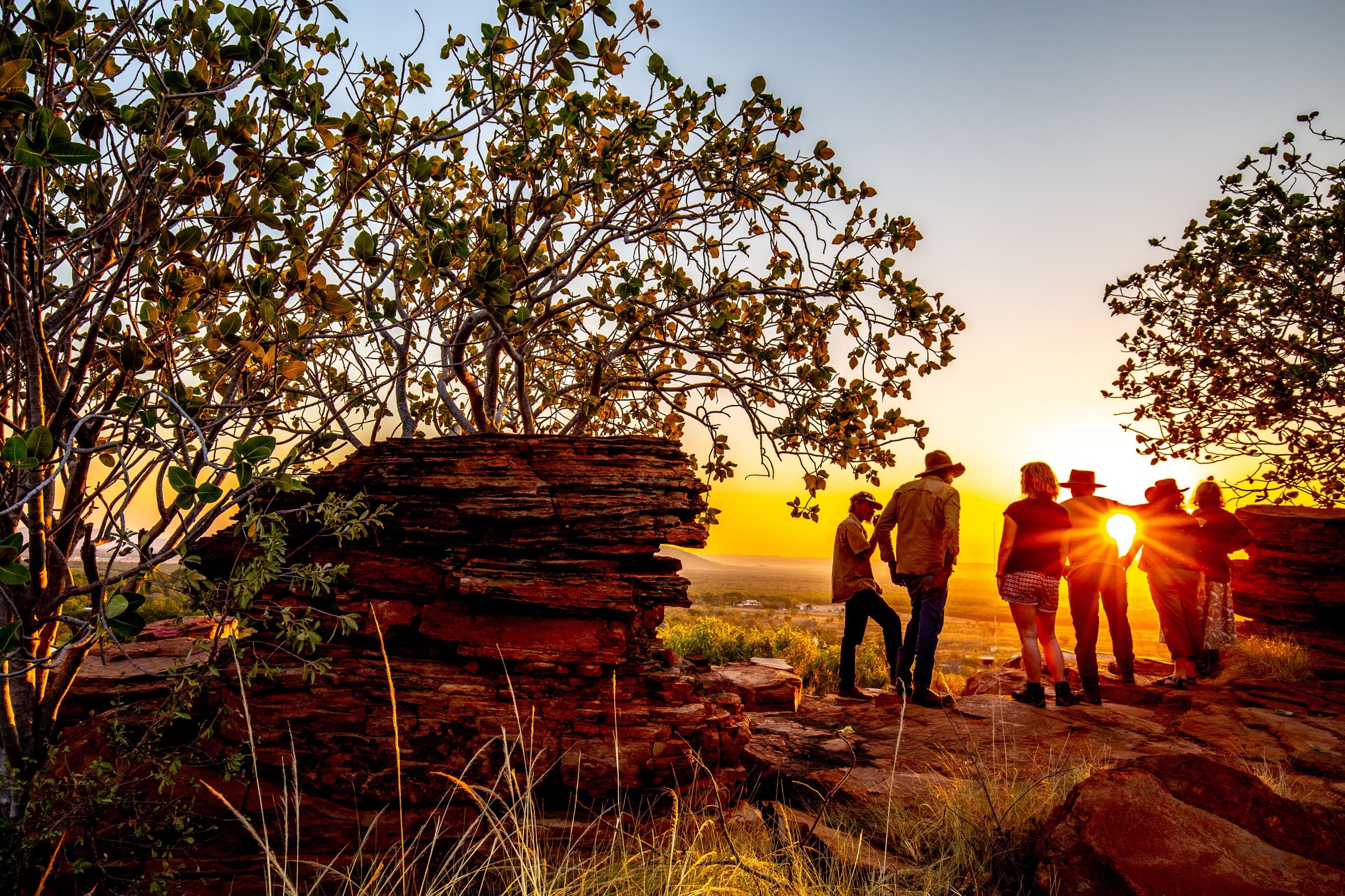 Sunset hike over red rock escarpment with guided bushwalk group