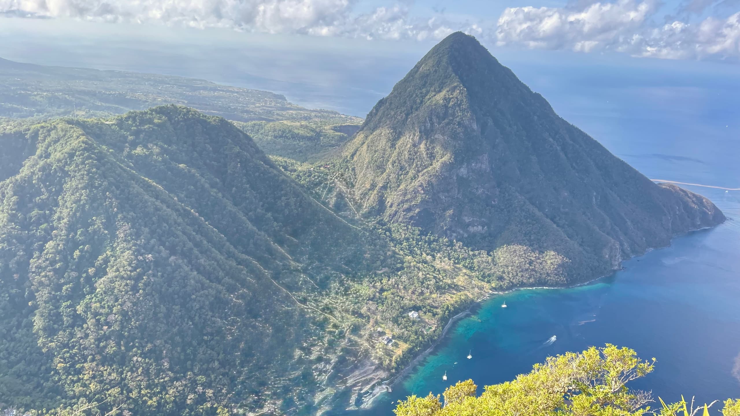 Aerial view of twin volcanic peaks and turquoise bay, hiking vista