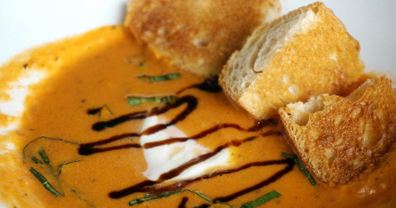 Creamy tomato soup with toasted bread, restaurant comfort meal