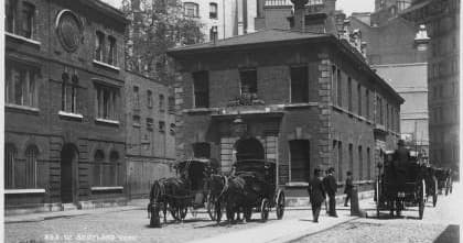 Historic London street with horse-drawn carriages on walking tour