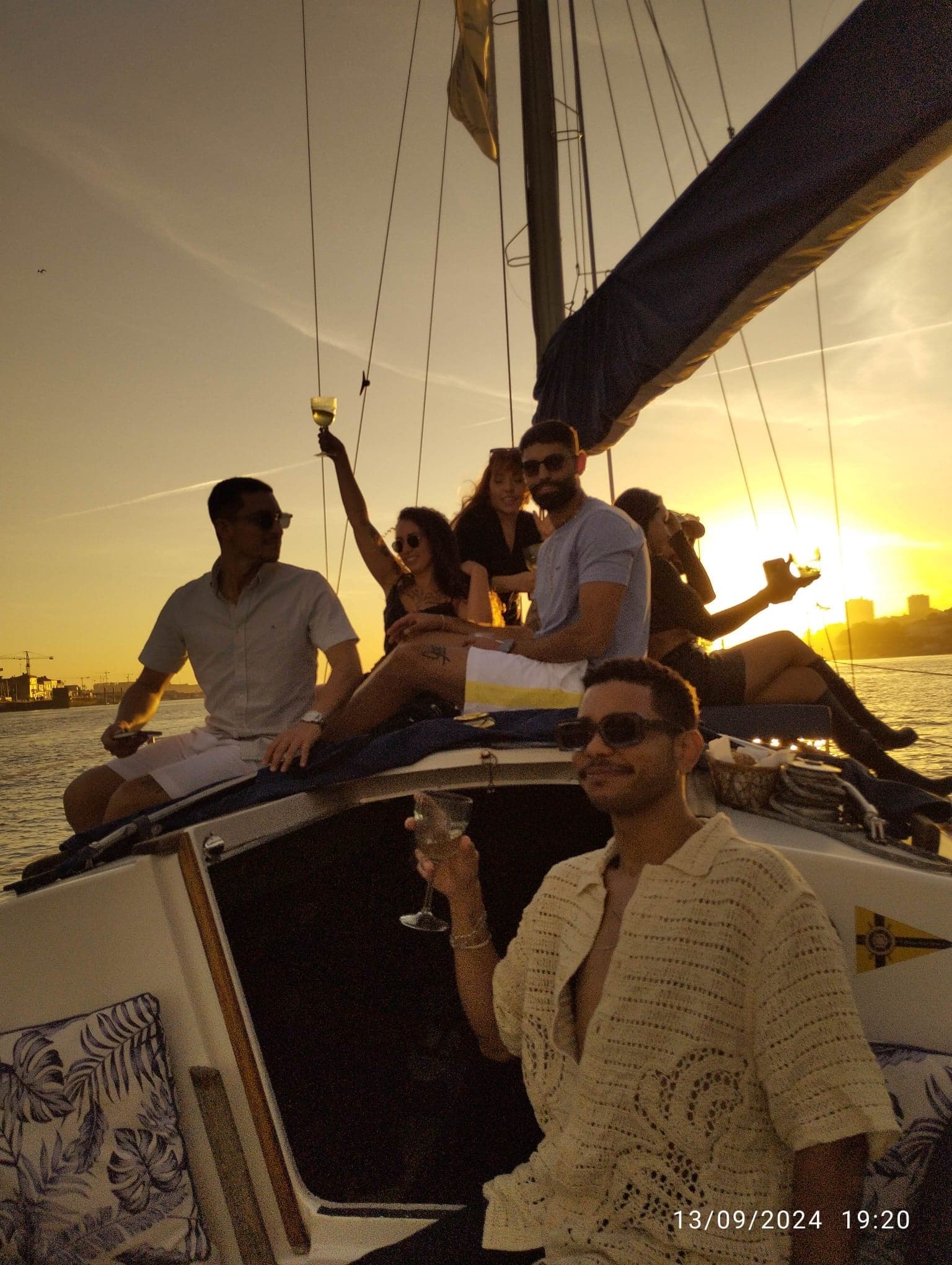 Group on sailboat at sunset on Douro River, celebrating cruise