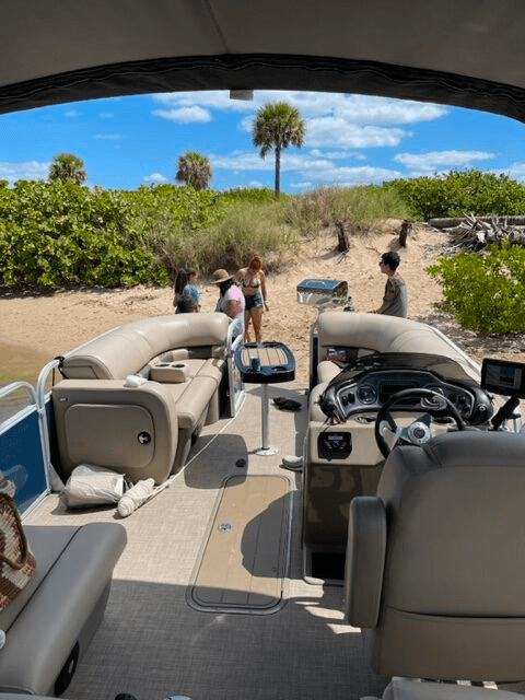 Beach landing from pontoon interior, guests disembarking to shore