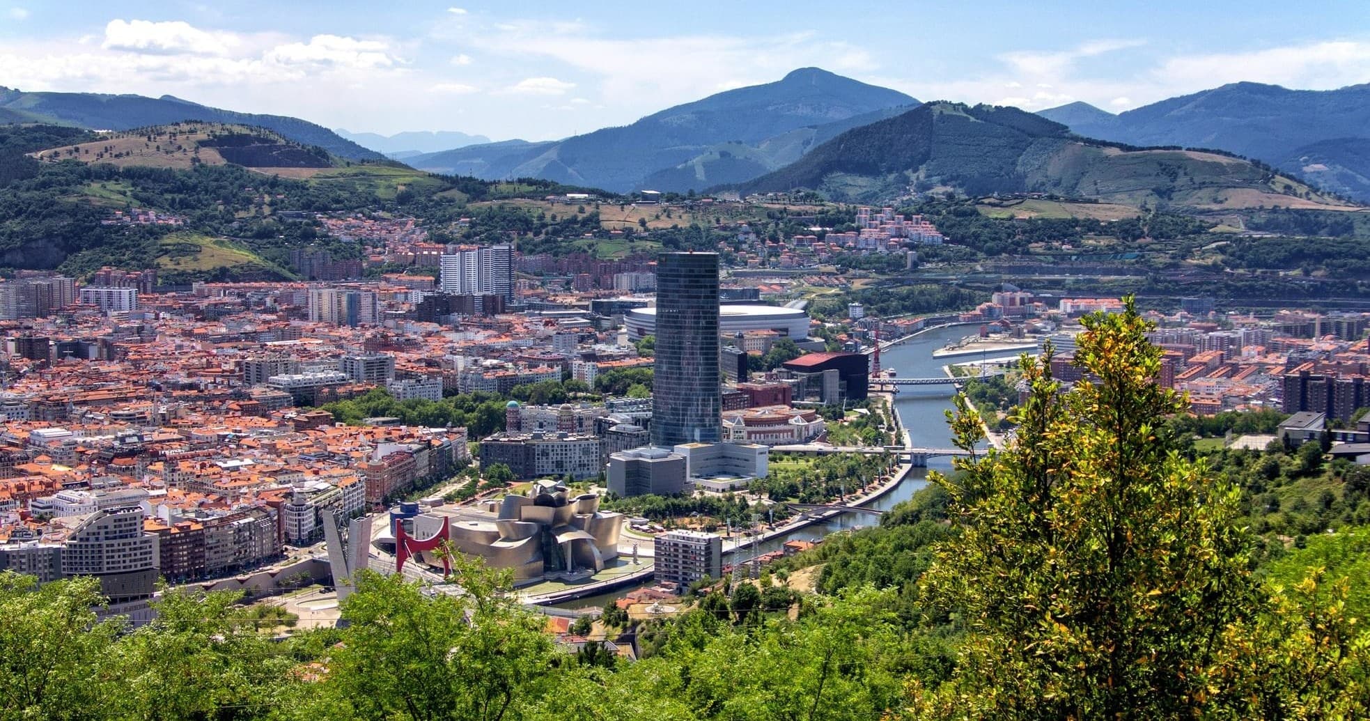 Panoramic Bilbao cityscape from hillside viewpoint, scenic overlook