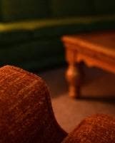 Cozy living room close-up with sofa and wooden coffee table indoors