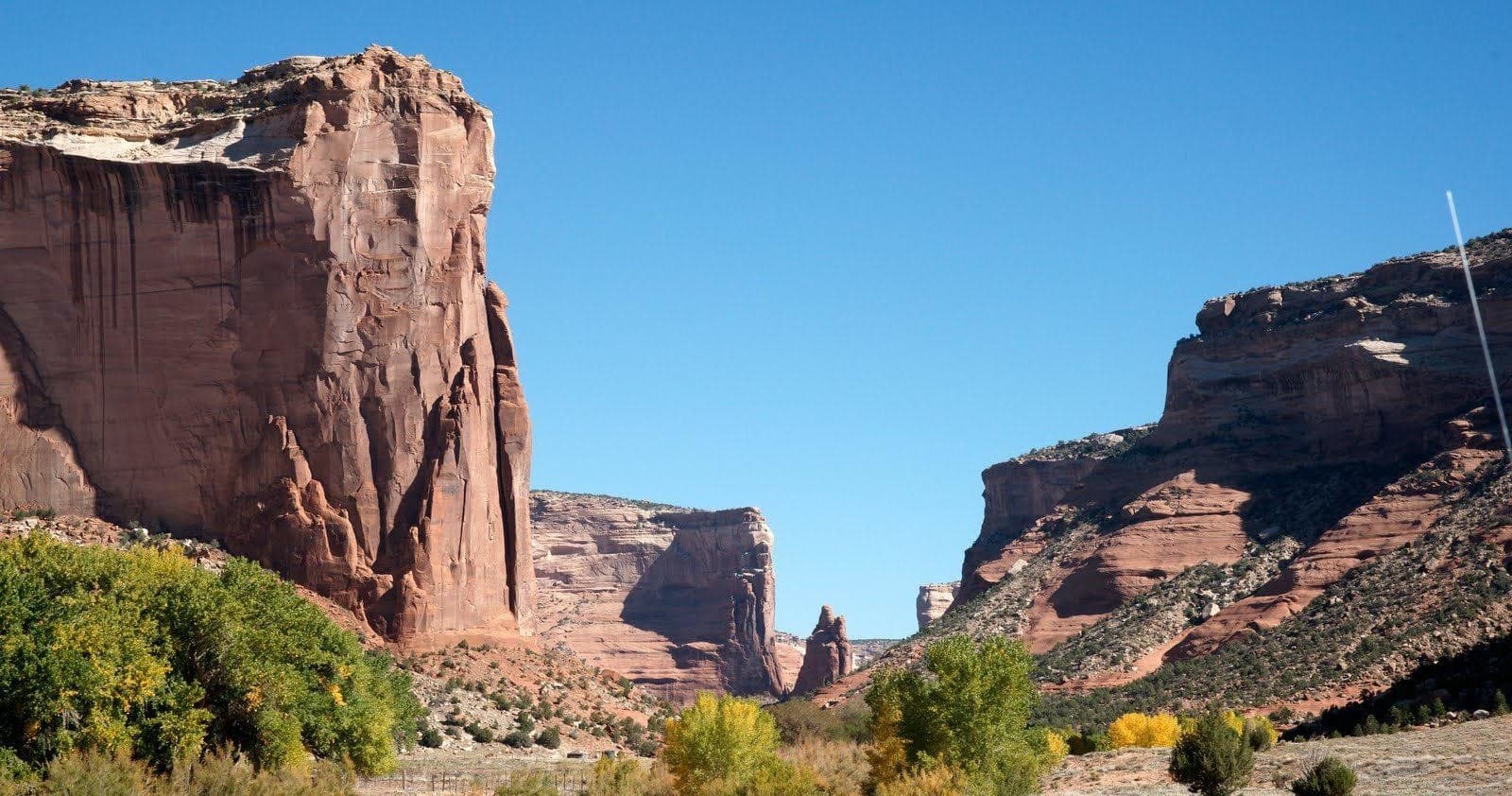 Scenic canyon valley with sandstone cliffs and clear blue sky