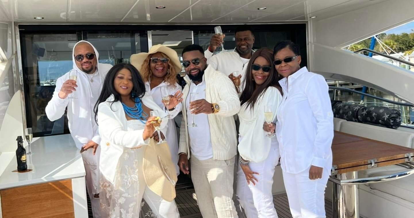 Group celebrating on luxury yacht deck during daytime cruise