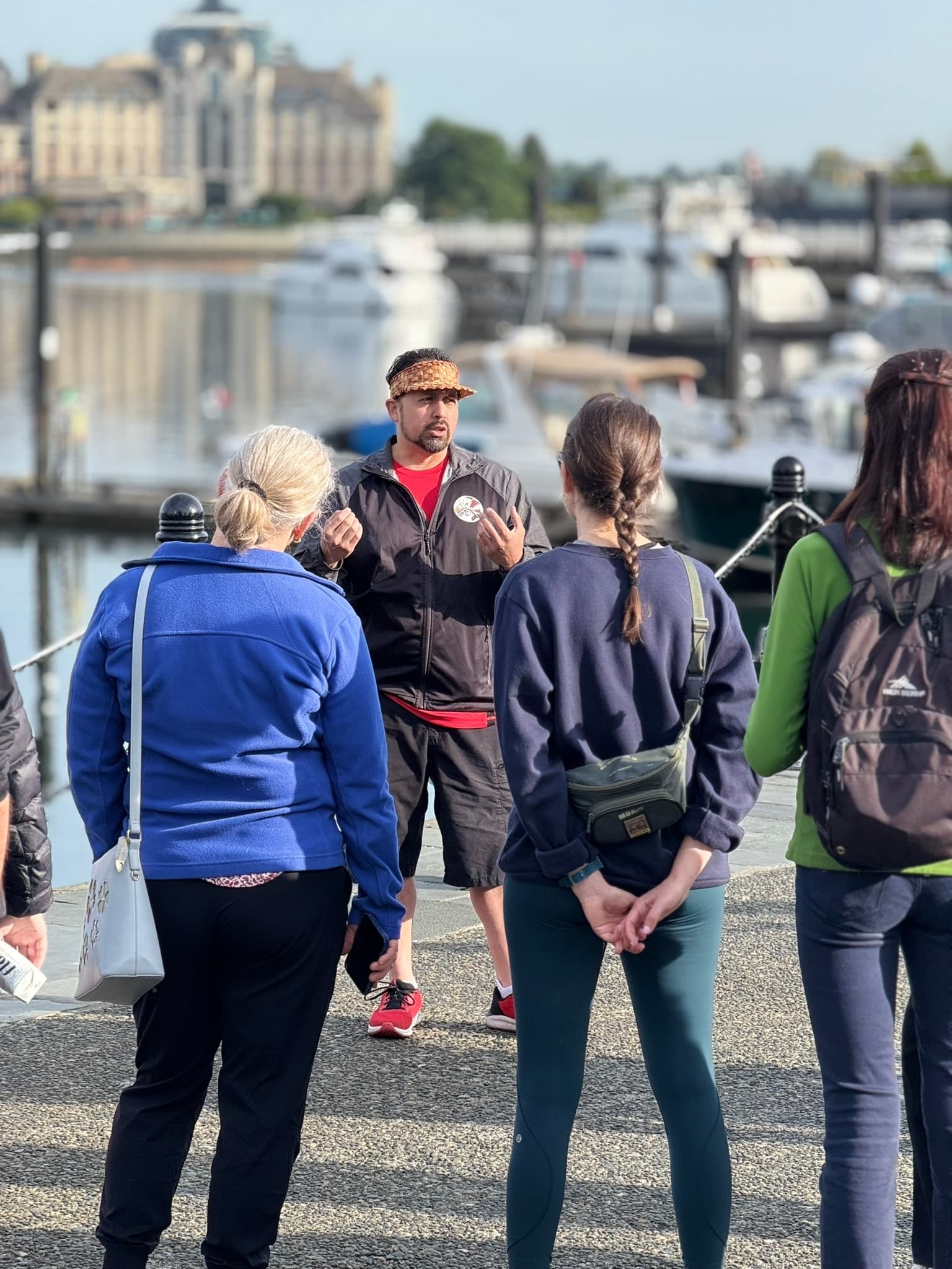 Guide briefing waterfront walking tour near city marina and docks