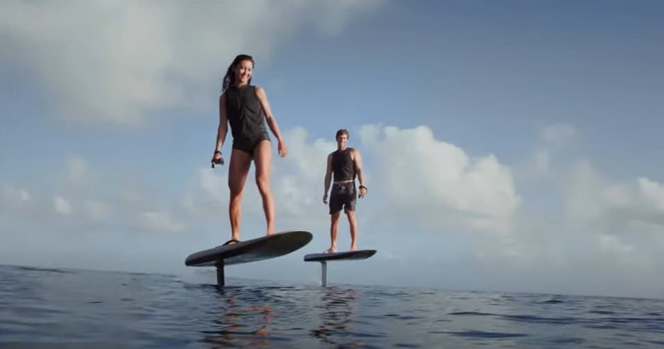 Two riders e-foiling on open ocean, hydrofoil board adventure
