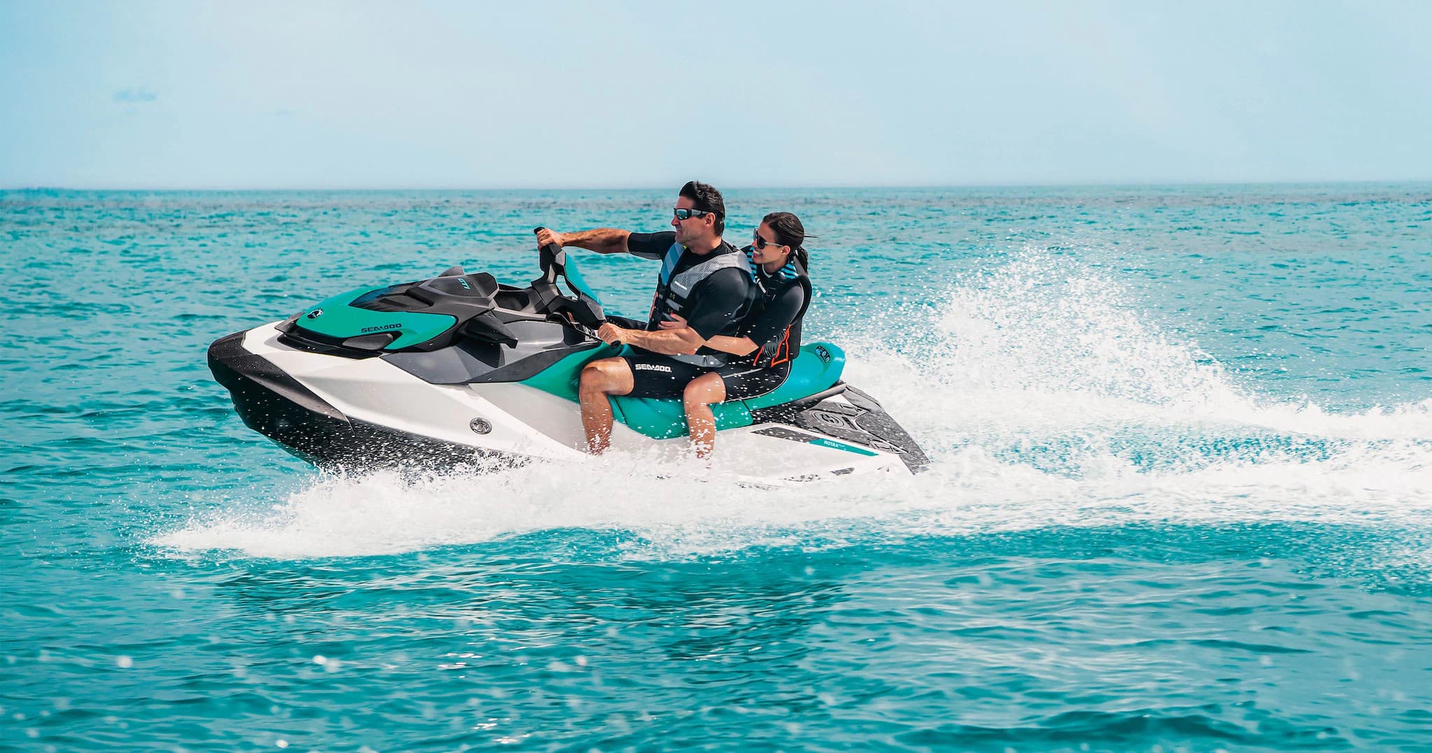 Riders jet skiing on turquoise ocean water near Daytona Beach