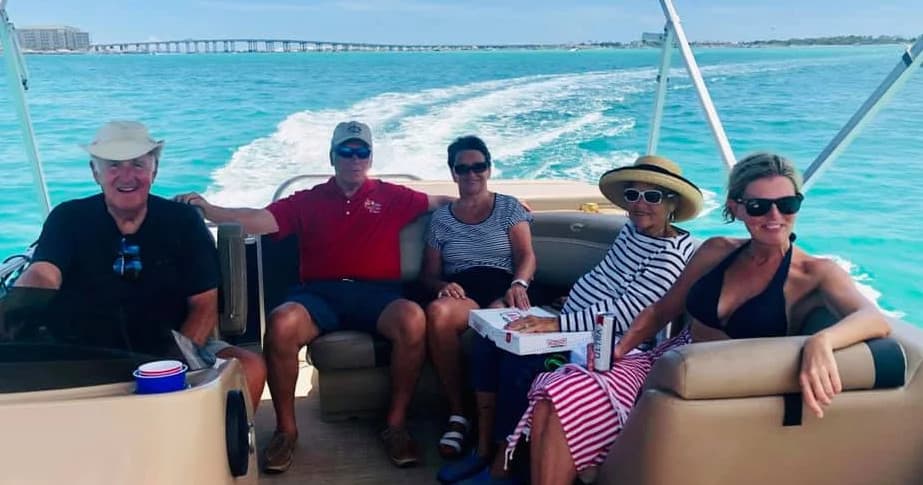 Friends on pontoon boat cruising turquoise Gulf waters