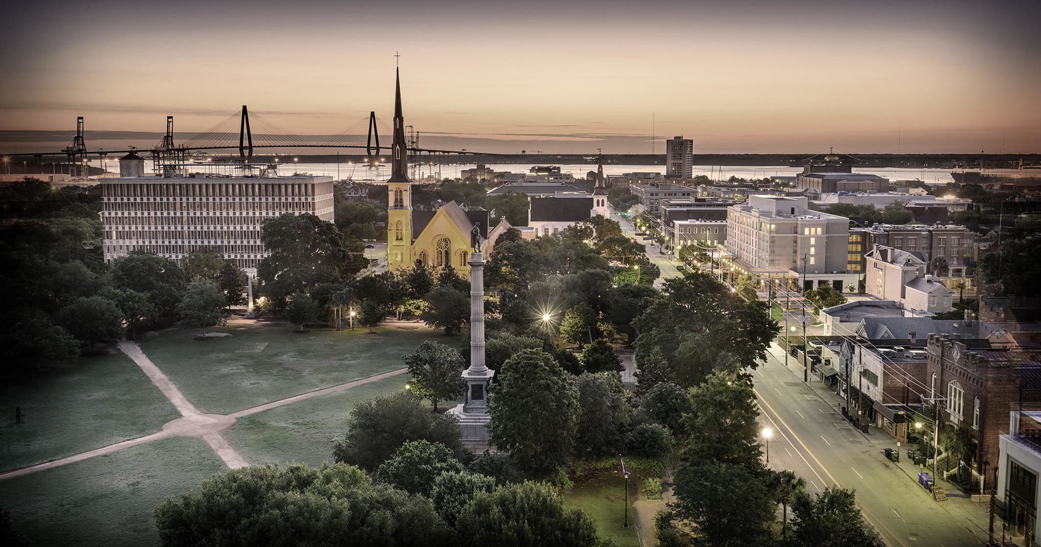 Aerial view of historic Charleston park and harbor at sunset