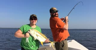 Anglers battling fish on inshore waters, action sport fishing trip