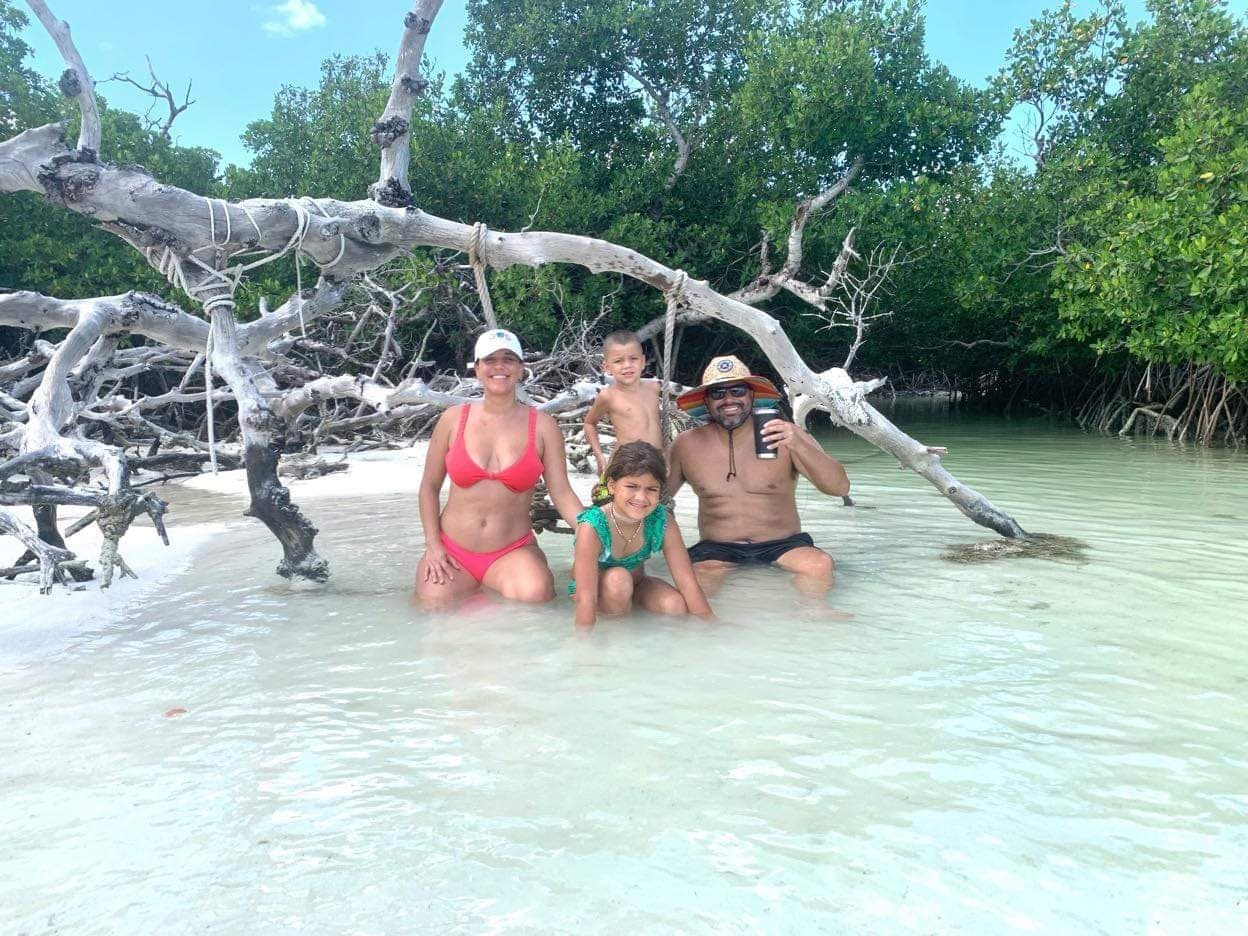 Family wading on mangrove island beach, Florida Keys