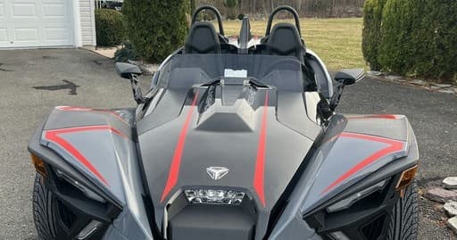 Open-air Polaris Slingshot three-wheeler parked outdoors