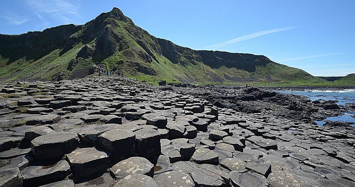 Basalt hexagonal rock formations on rugged coastal shore