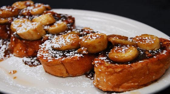 Caramelized banana French toast stack dusted with powdered sugar