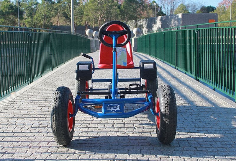 Four-wheeled pedal kart on pedestrian bridge for family fun rides