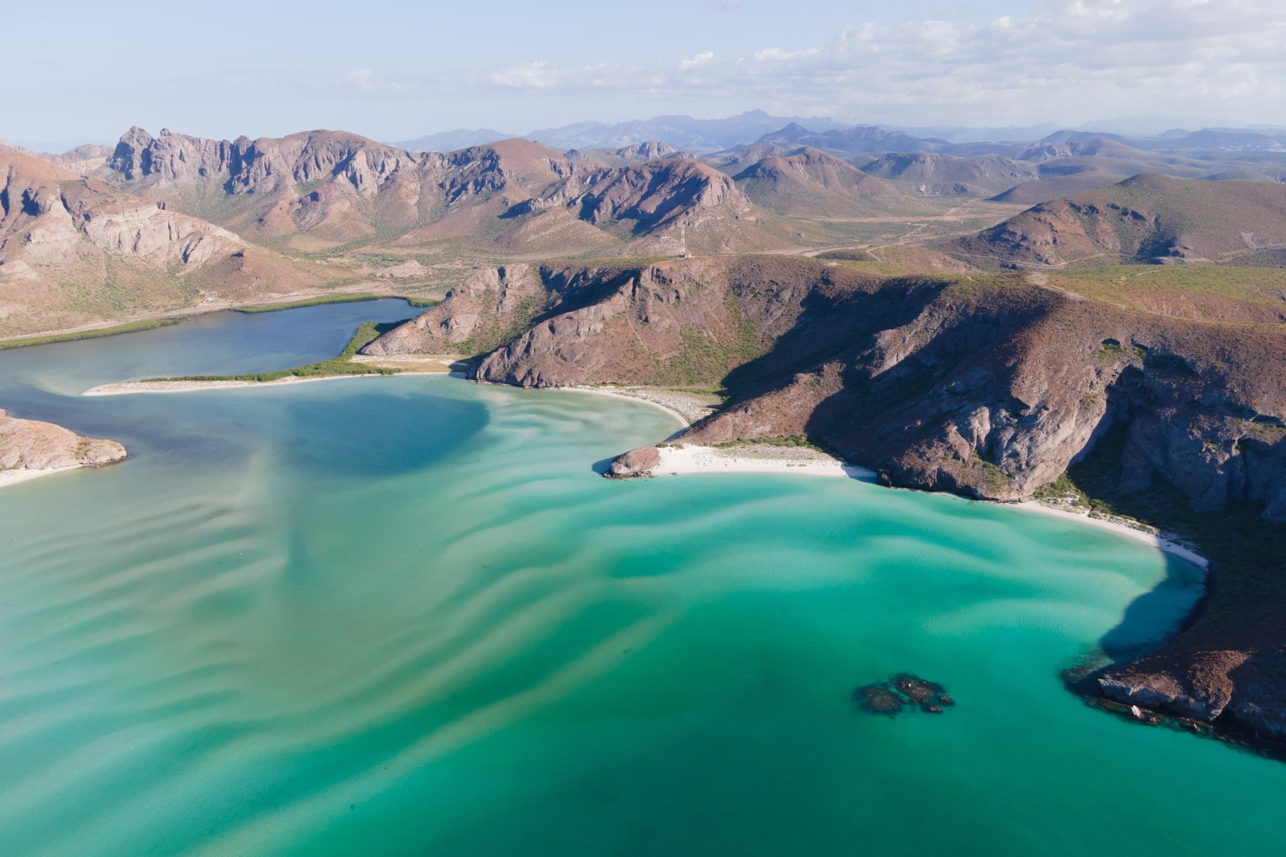 Aerial view of turquoise bay and rugged Baja California coastline