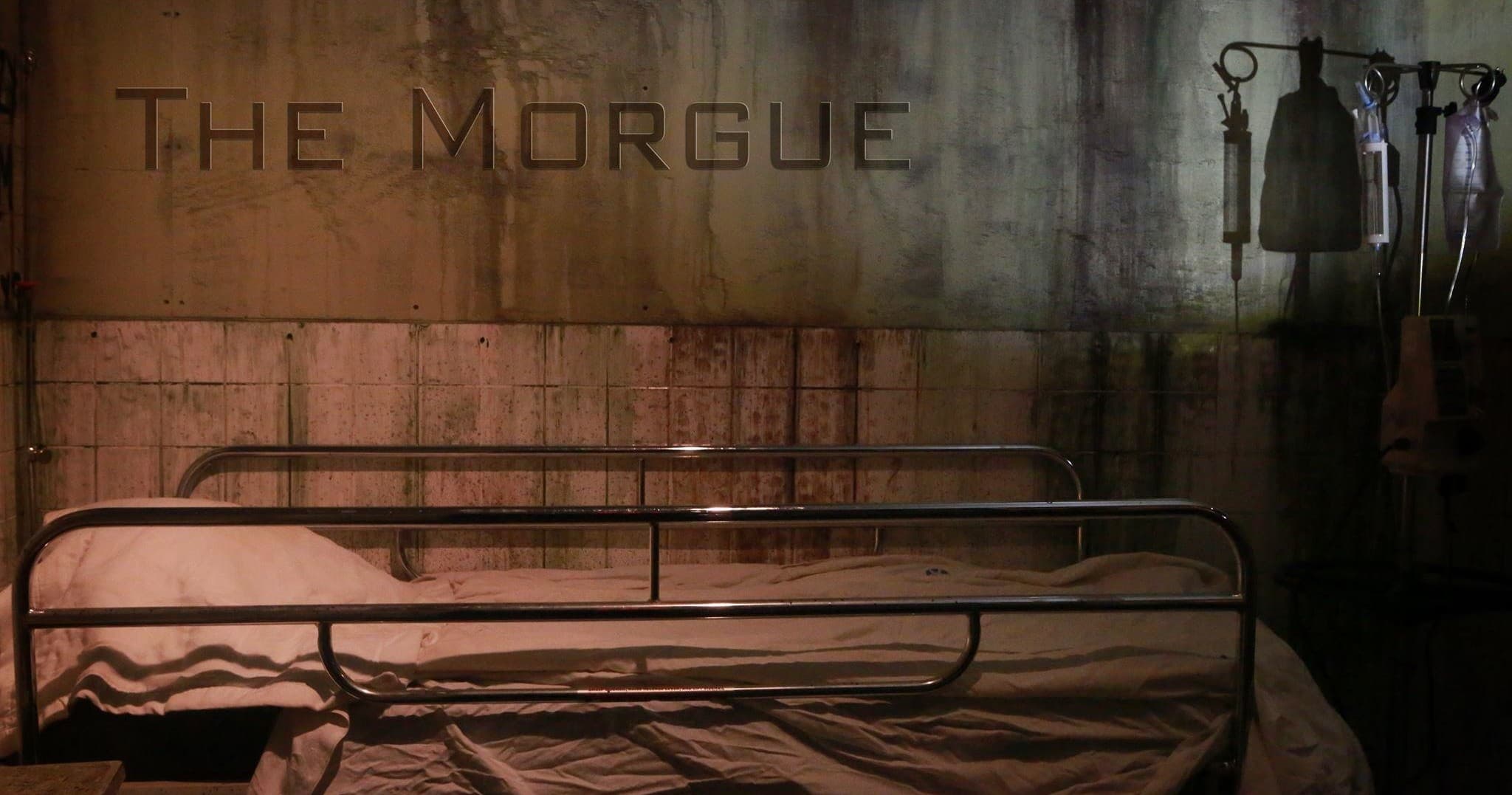 Escape room morgue set with metal gurneys, eerie indoor scene