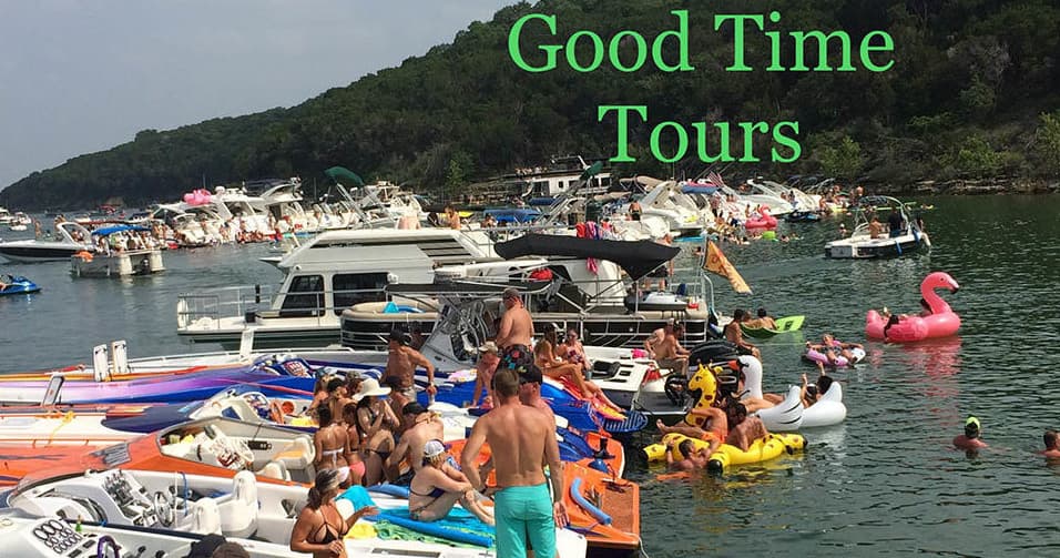 Crowded boat party with multiple pontoons and inflatables