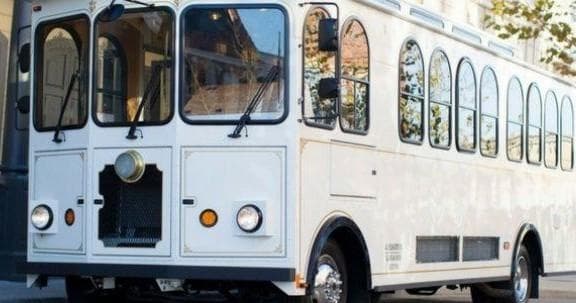 Antique-style white trolley at vineyard for scenic wine tours