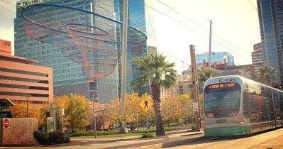 Valley Metro light rail passing downtown Phoenix palm-lined street