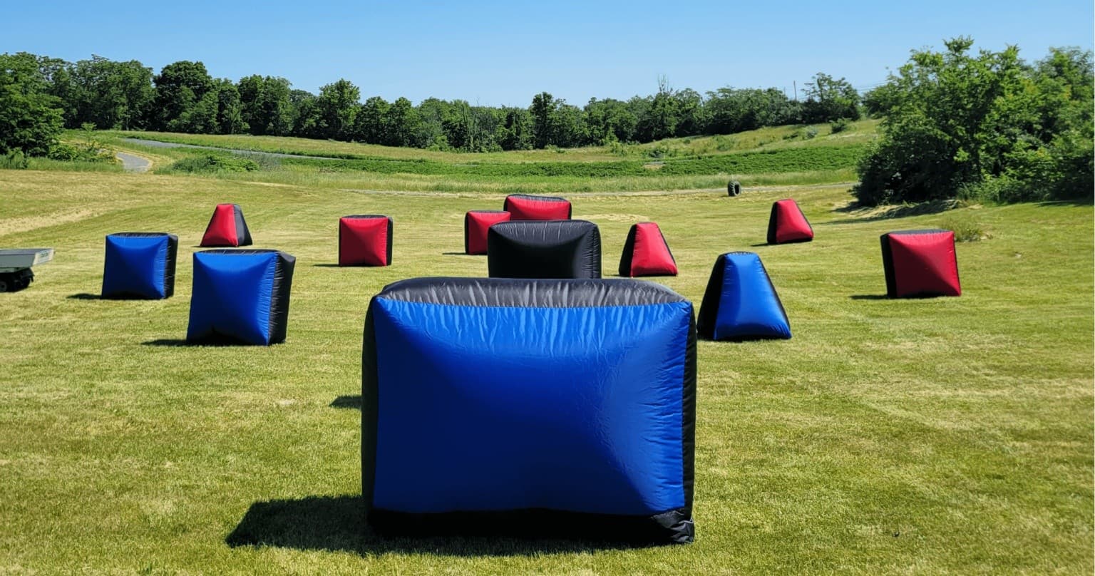 Paintball inflatable bunkers on grassy outdoor field