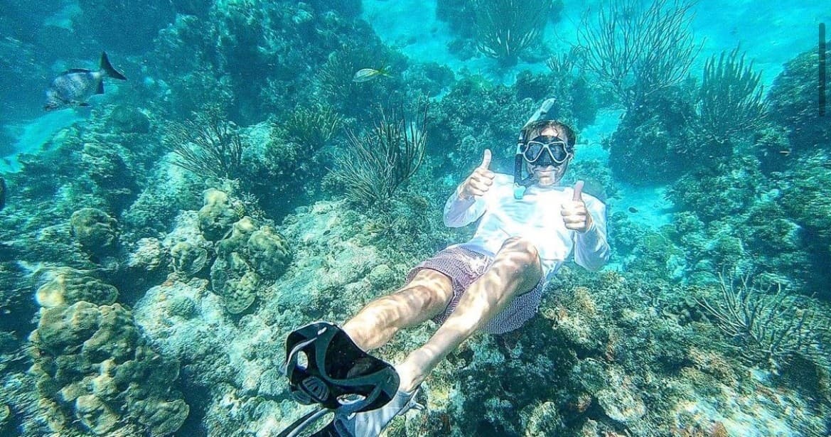 Snorkeler exploring coral reef in clear Florida Keys turquoise water