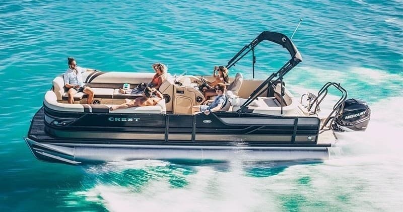 Pontoon boat cruising turquoise open ocean with passengers