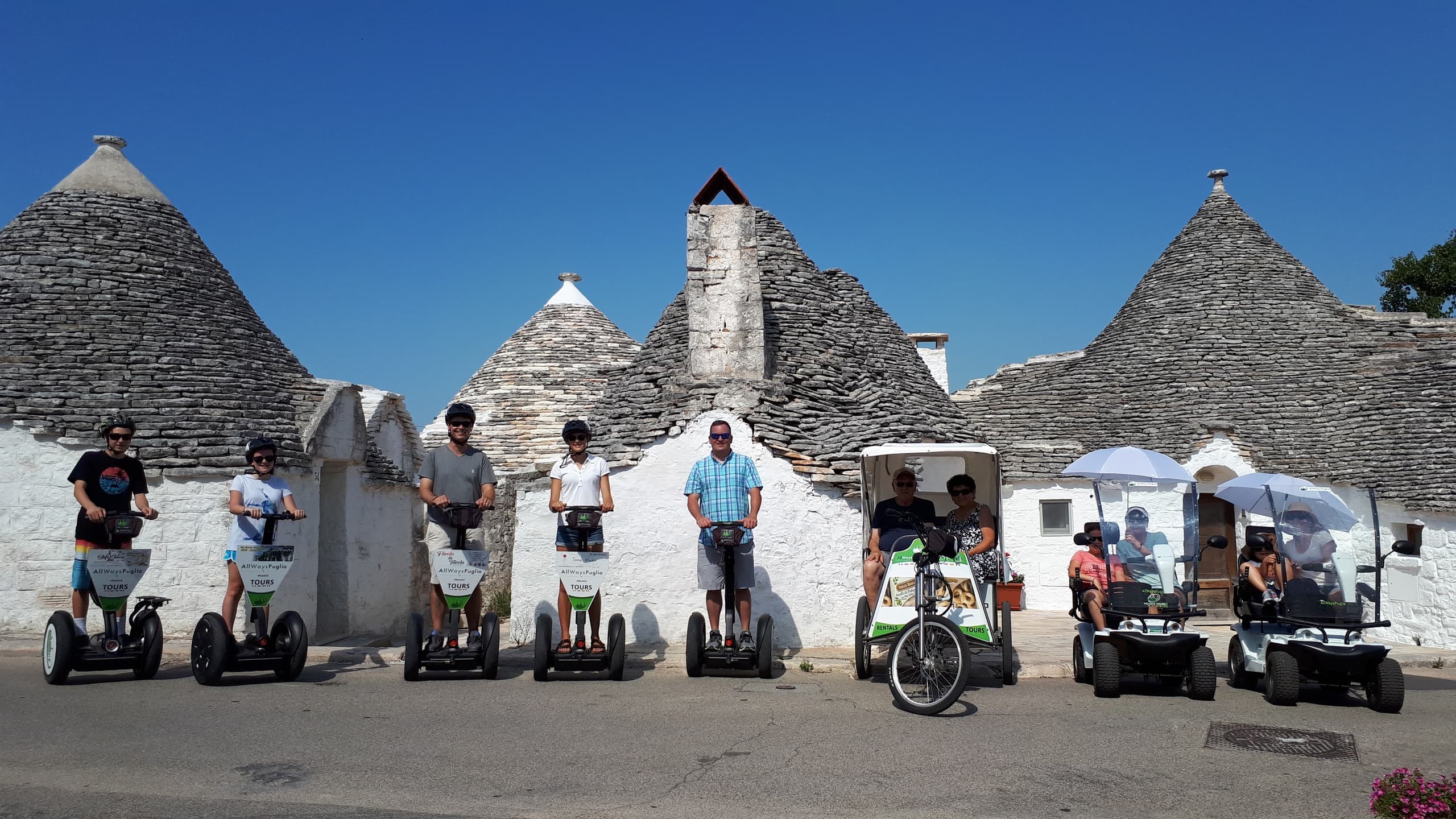 Segway tour group lined up by trulli stone cottages in Puglia
