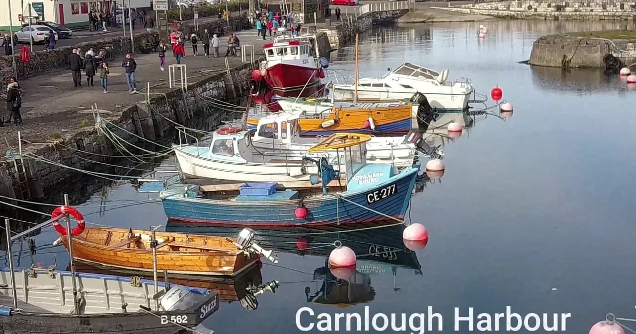 Small fishing boats moored in Carnlough Harbour, tranquil harbor view