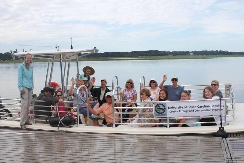 Group aboard pontoon boat exploring scenic coastal marshes