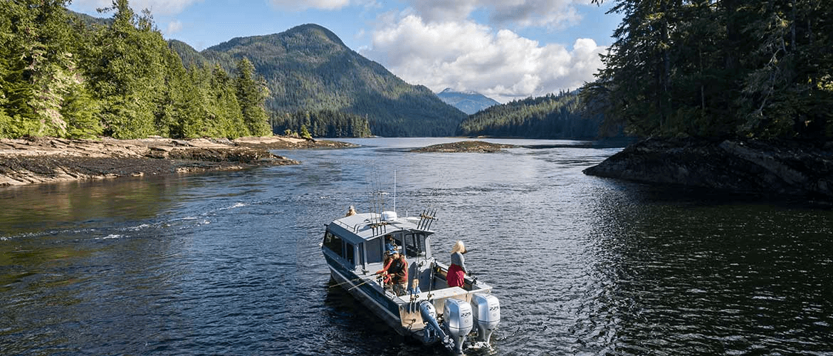 Charter fishing boat cruising a scenic coastal inlet in Alaska