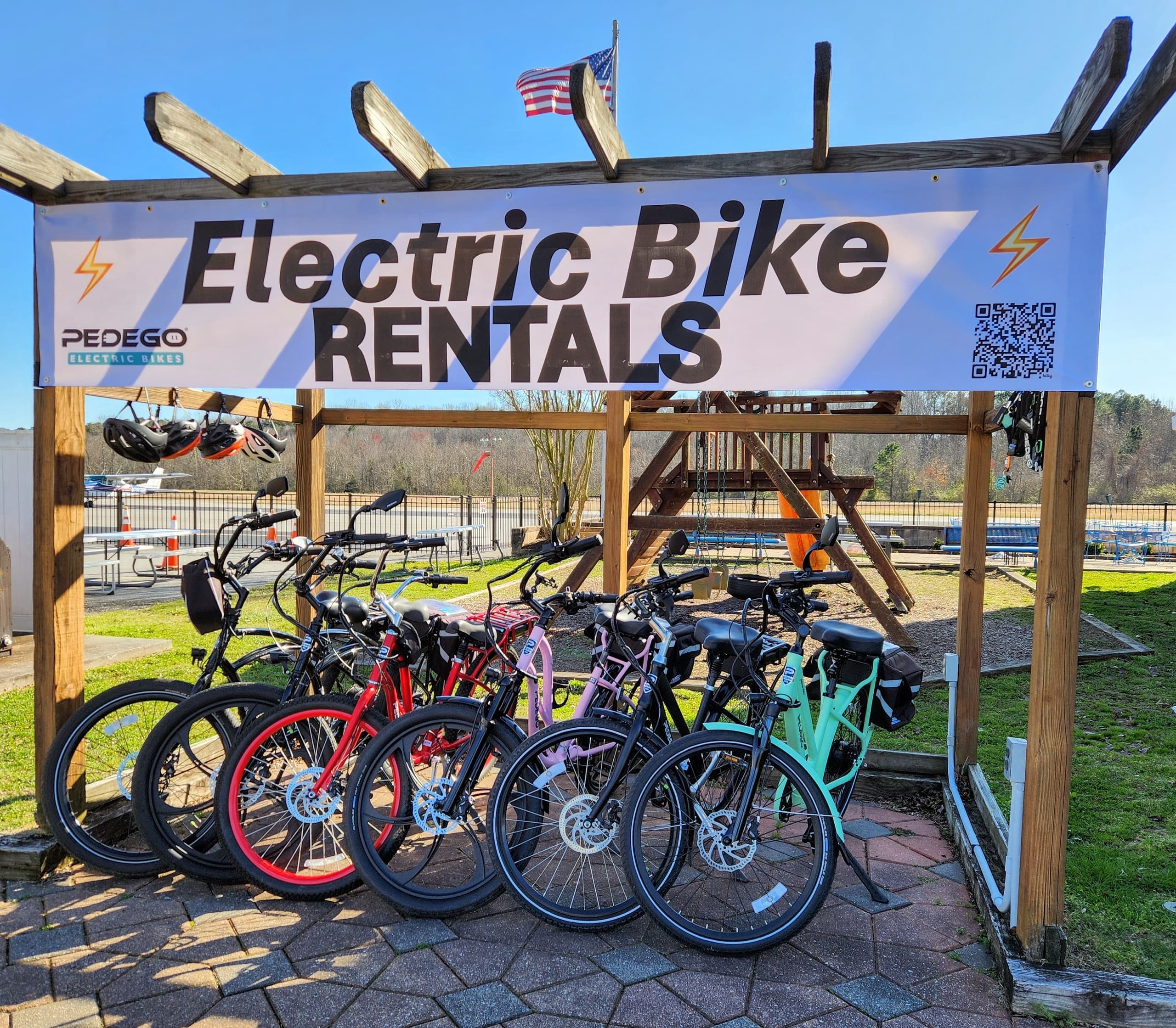 Colorful electric bike rental display at outdoor shop