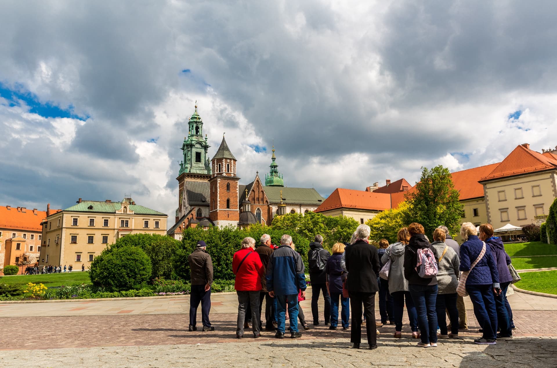 Guided tour group at Krakow cathedral square, outdoor historic walking tour