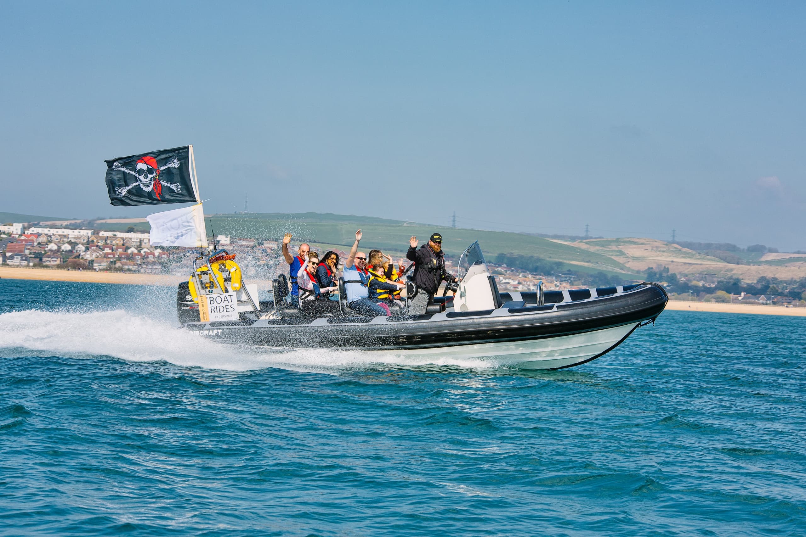 High-speed RIB tour with passengers enjoying coastal speed ride