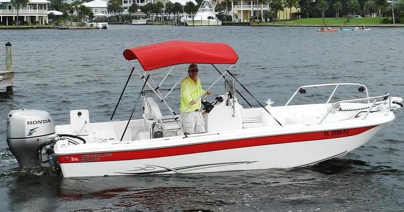 Small center console boat on calm bay, family fishing charter