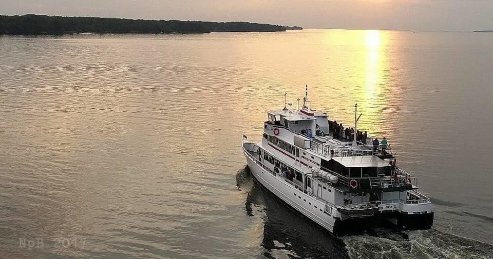 Evening ferry sailing into sunset over coastal archipelago