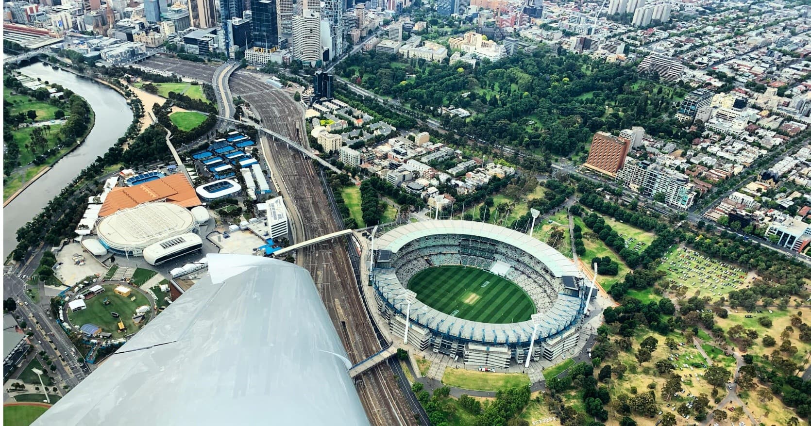 Bird's-eye view of stadium and city from airborne perspective