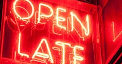 Red neon Open Late sign glowing in urban nightlife scene