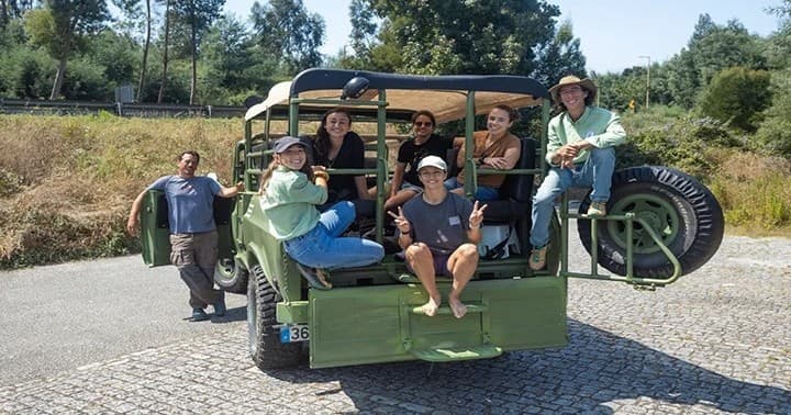 Group riding open-top jeep on scenic countryside day tour
