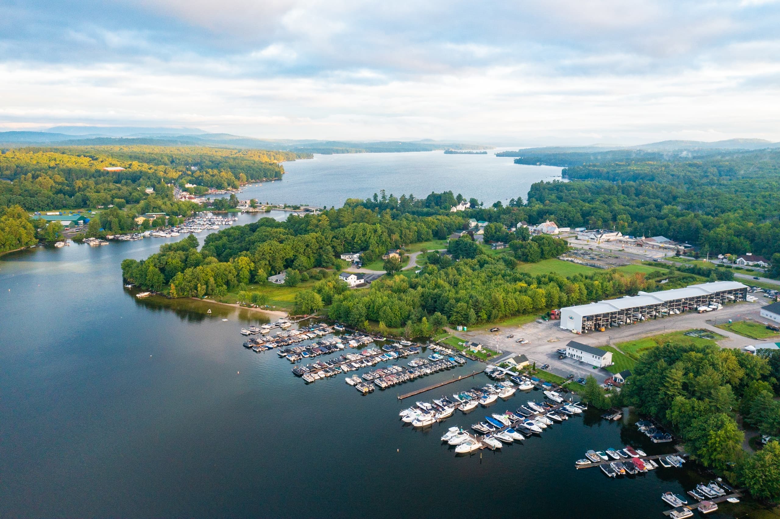 Expansive lake and marina aerial shot with distant horizon