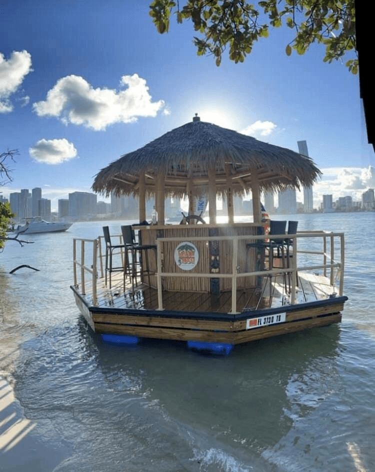 Floating tiki bar docked near Miami skyline for island boat fun