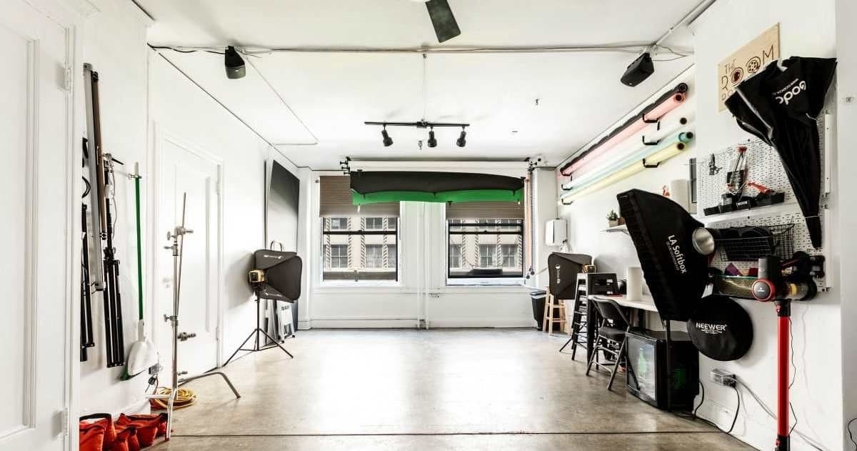 Photography studio set up for portrait shoot with lights and backdrops