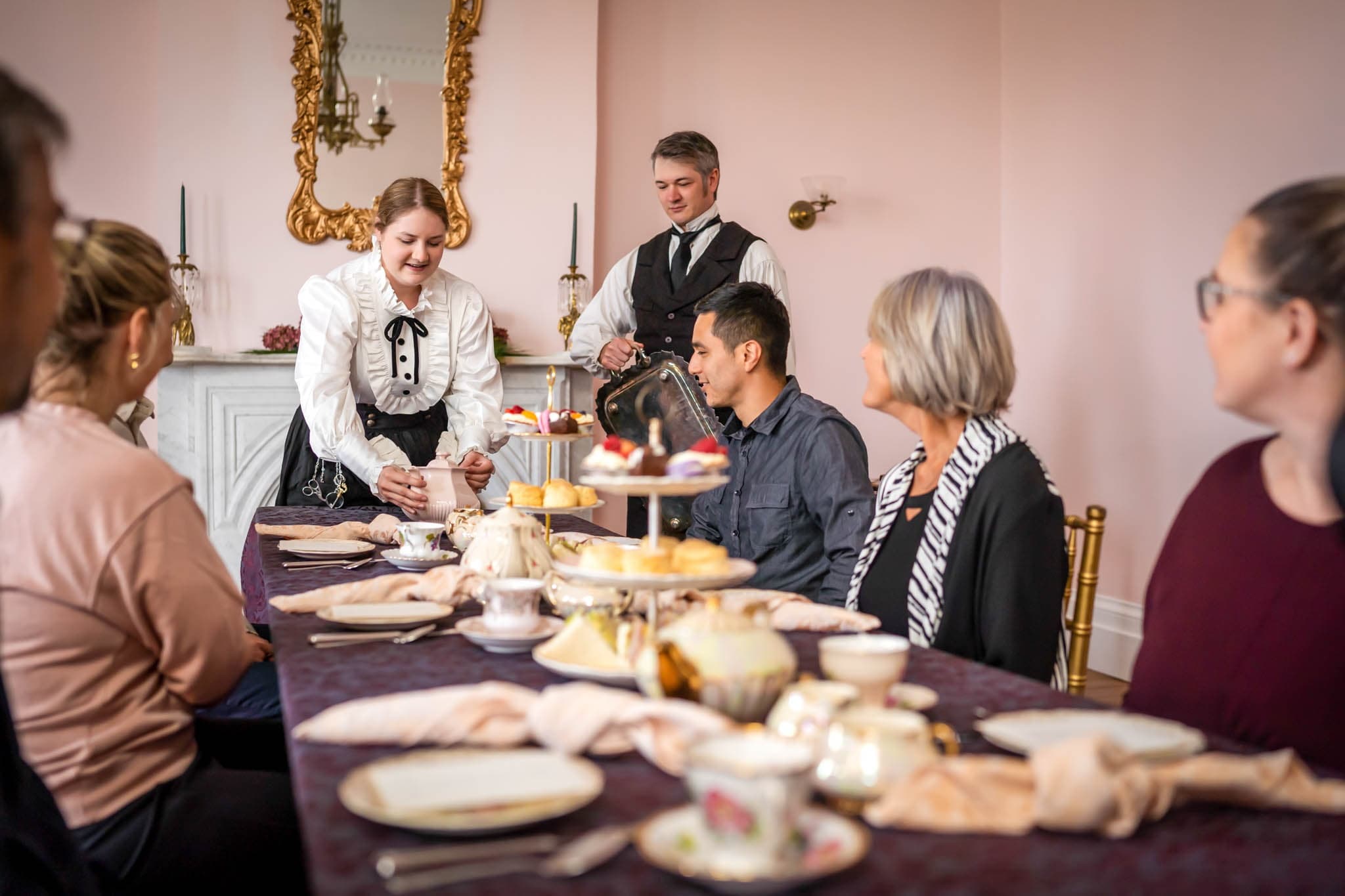 Group dining in elegant mansion dining room during event