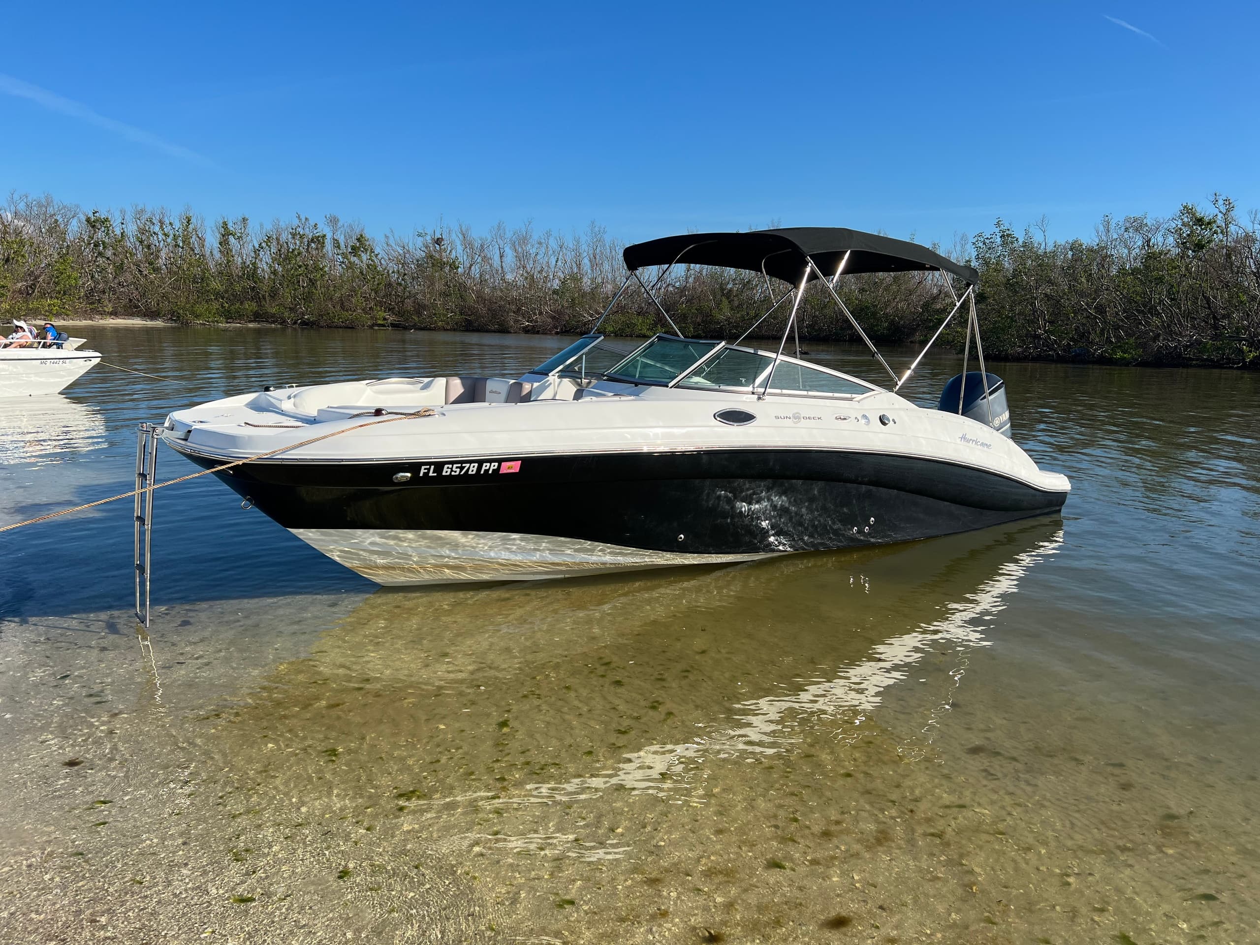 Bowrider beached in shallow clear water for coastal exploration