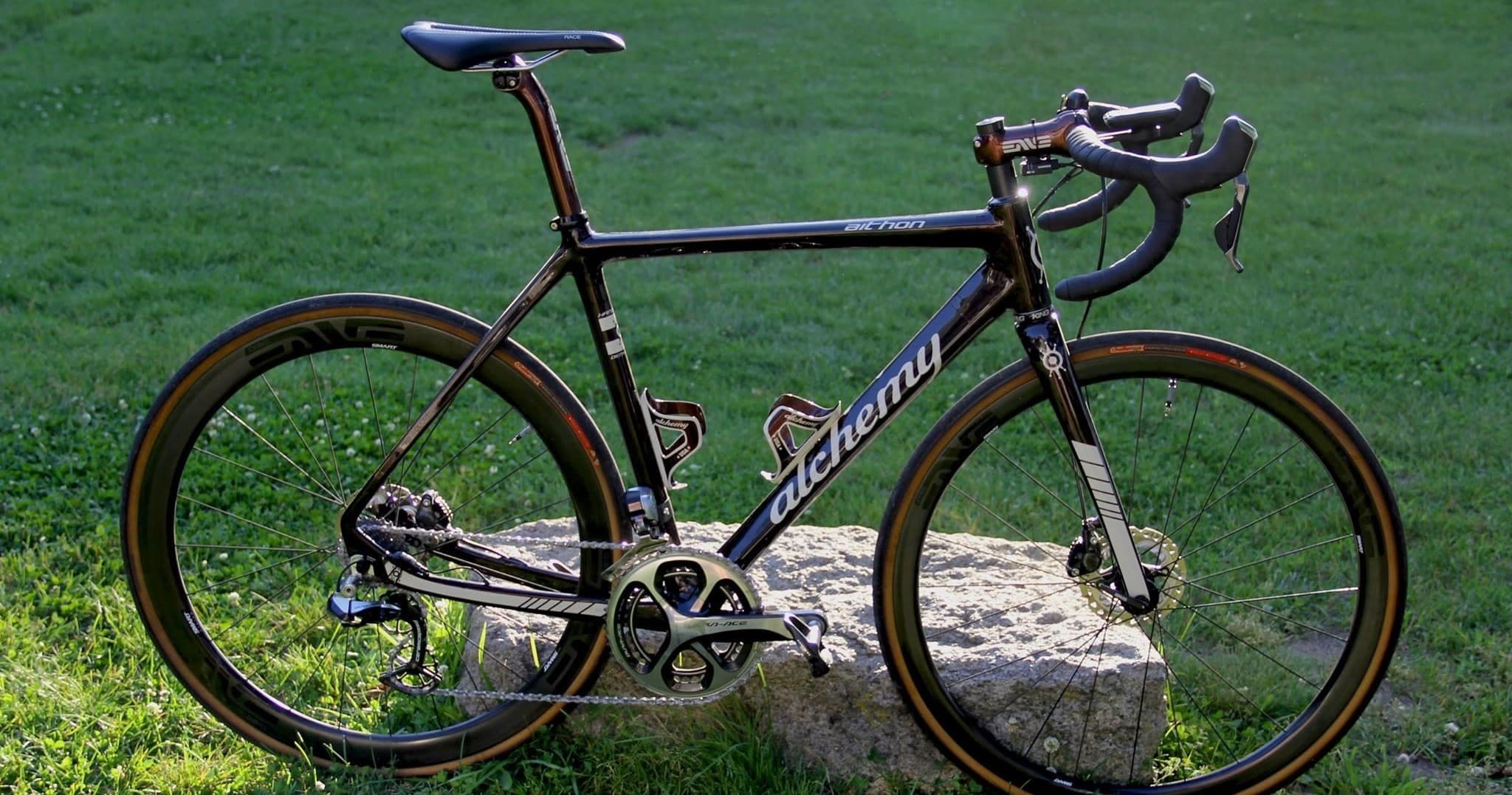 Road bike parked on grassy lawn, scenic cycling route prep