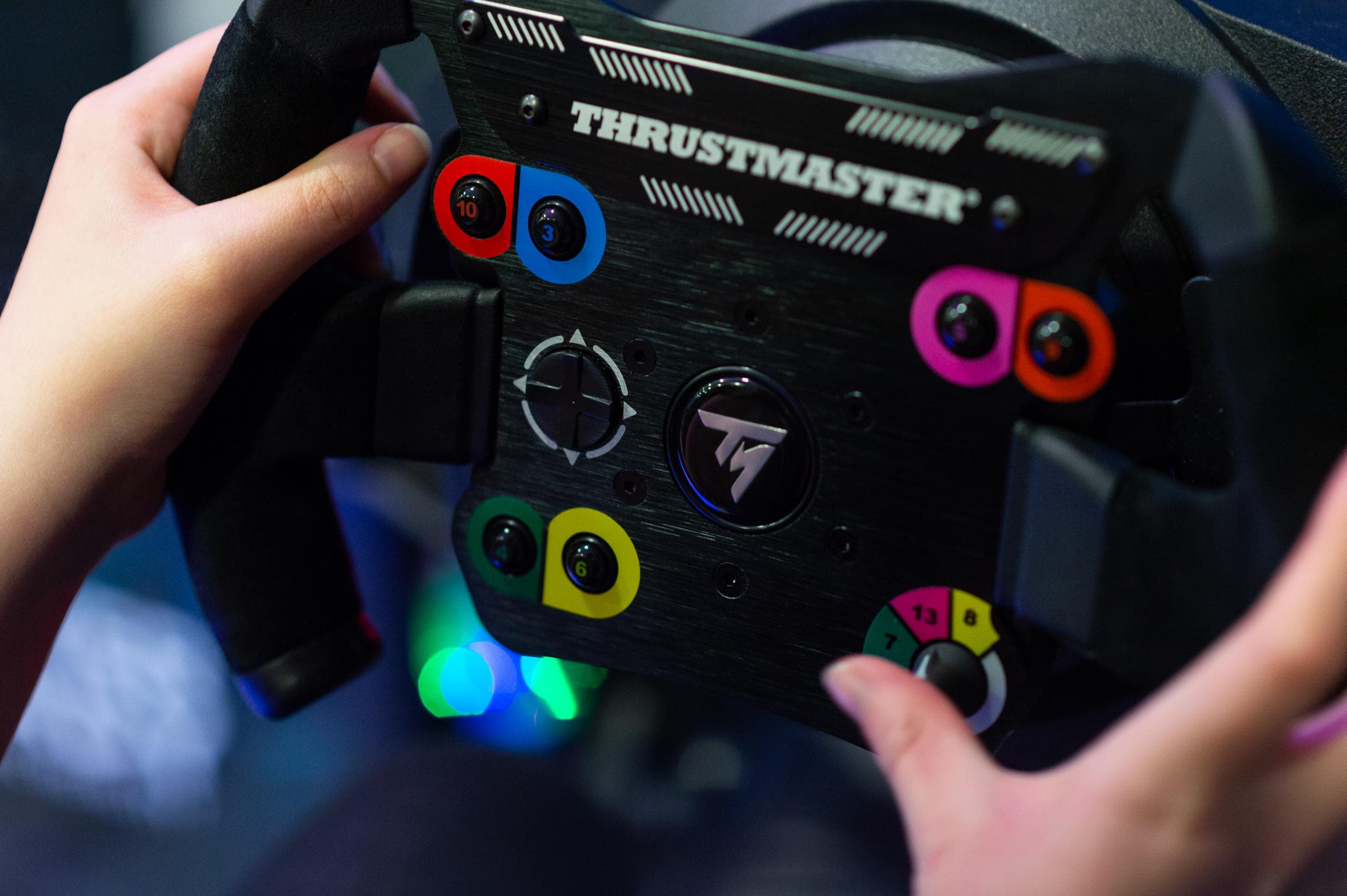 Hands on Thrustmaster racing wheel controller in gaming setup