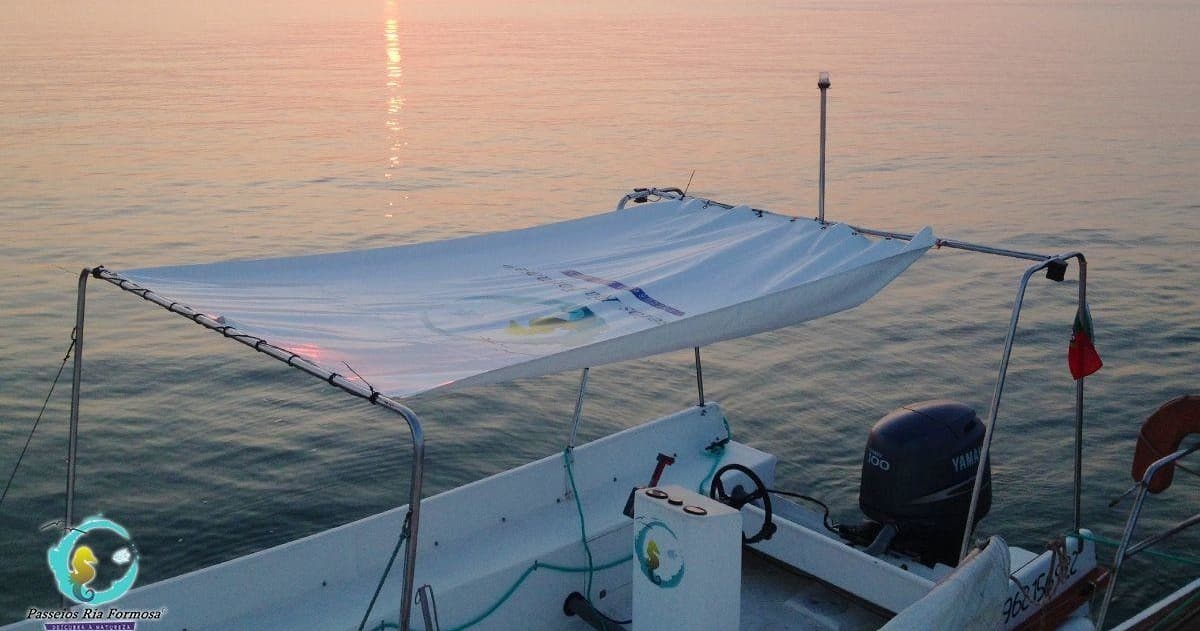 Sunset boat canopy and calm waters over Ria Formosa inlet