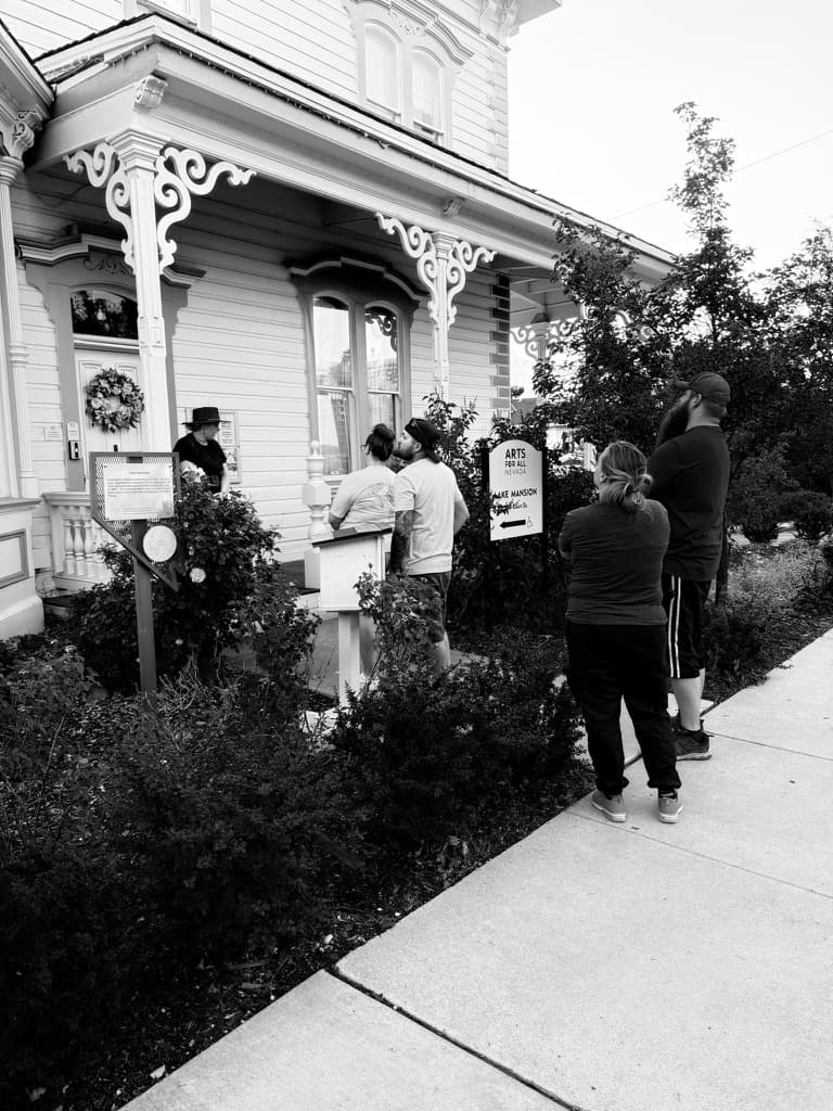 Guests queuing at Victorian porch on guided Reno haunted tour